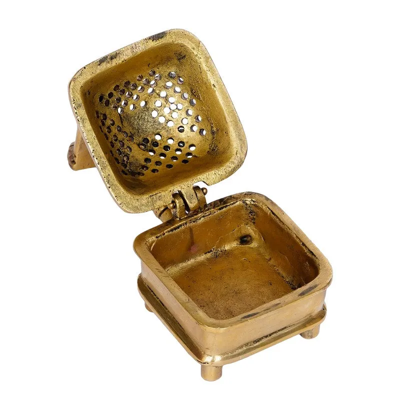 Top view of open brass incense holder with perforated lid