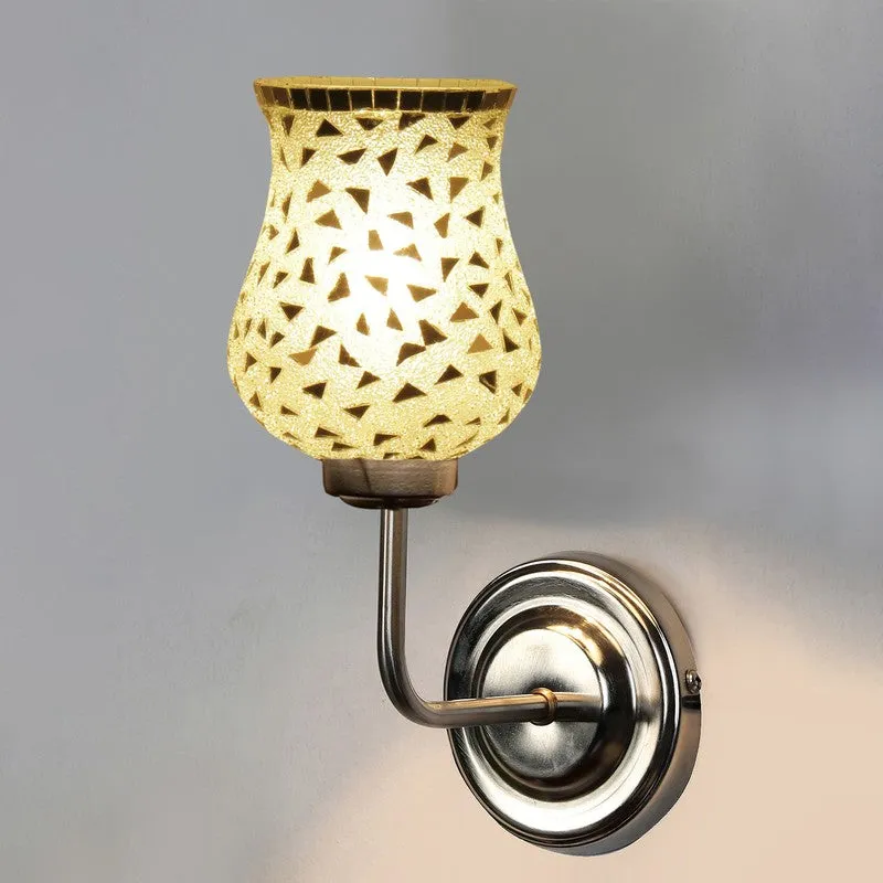 Close view of lit silver mosaic glass wall lamp