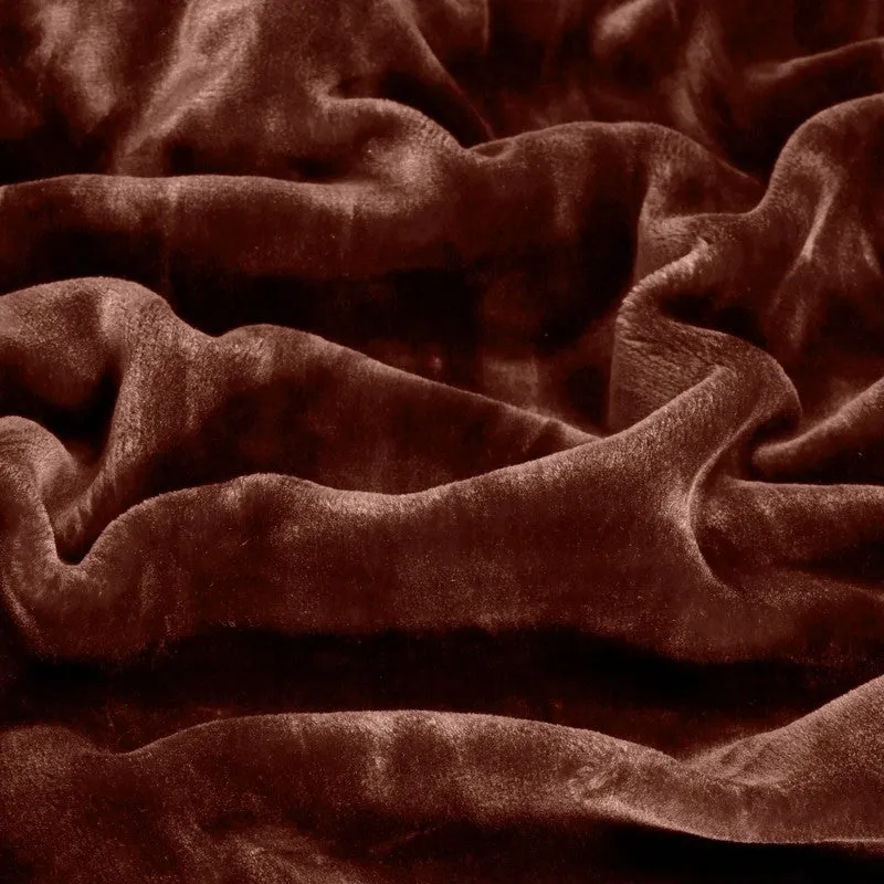 Close-up view of the blanket's rich brown plush surface and soft folds
