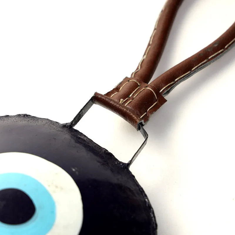 Close-up of the brown leather hanging loop attached to the bell