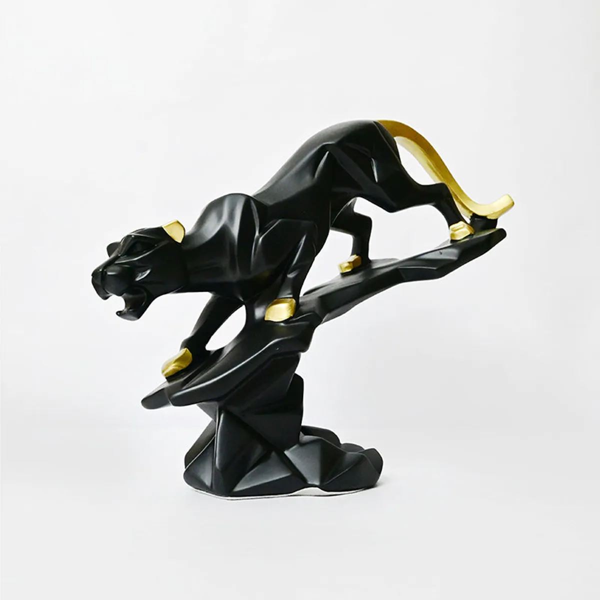 Side profile of a black panther showpiece with gold accents on a sculptural base