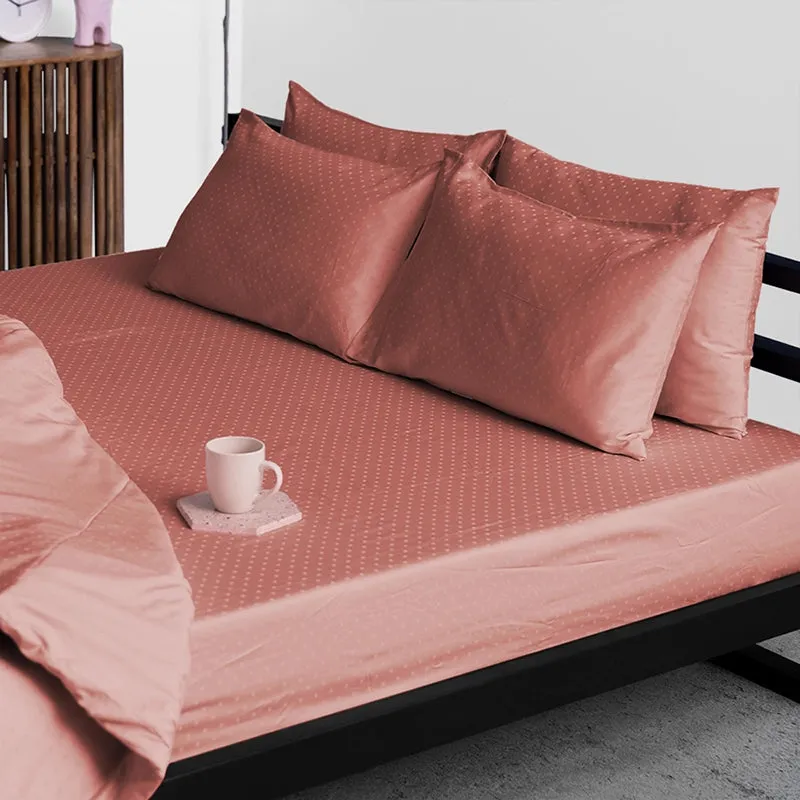 Pink-brown geometric dotted duvet cover on a contemporary bed