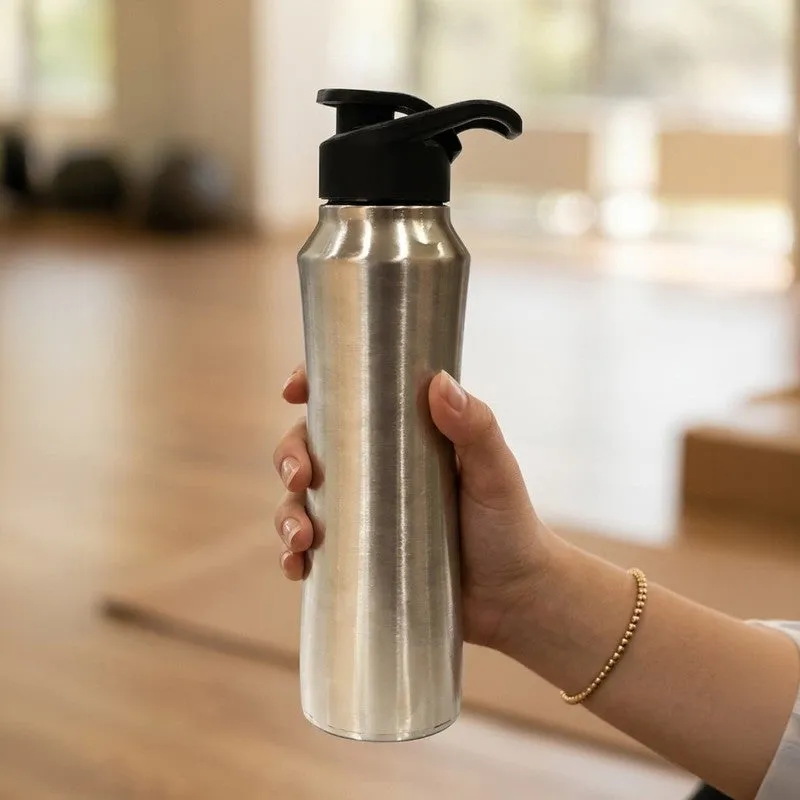 Hand holding a silver steel bottle with black sipper cap