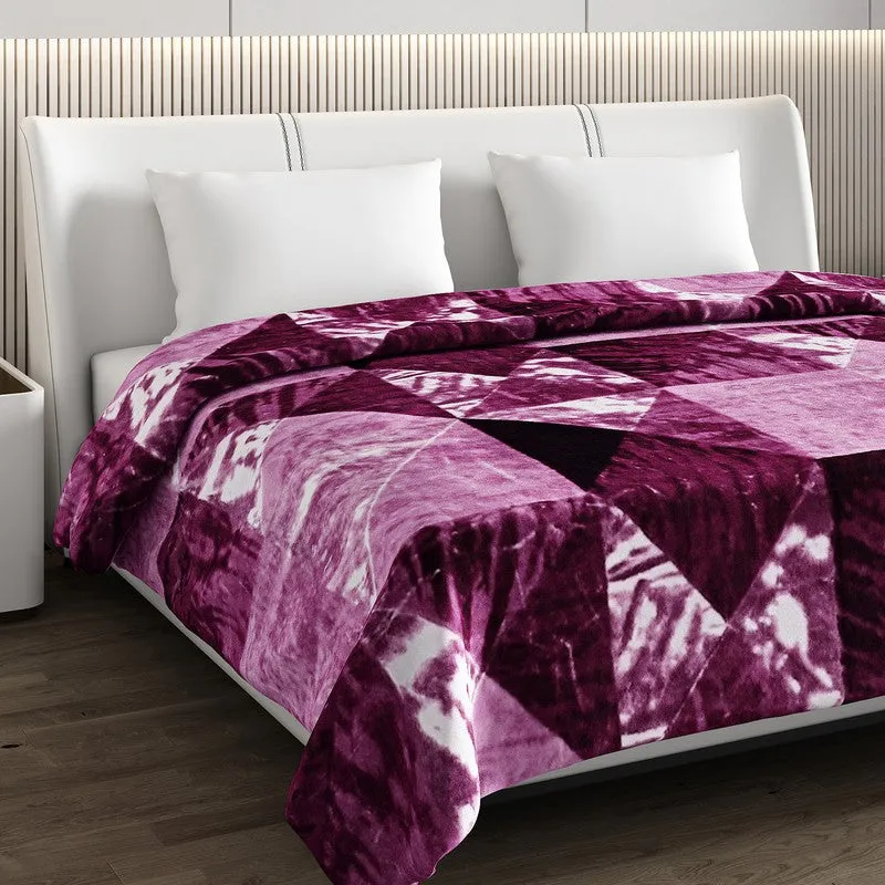 Close-up of the purple plush blanket draped over the bed