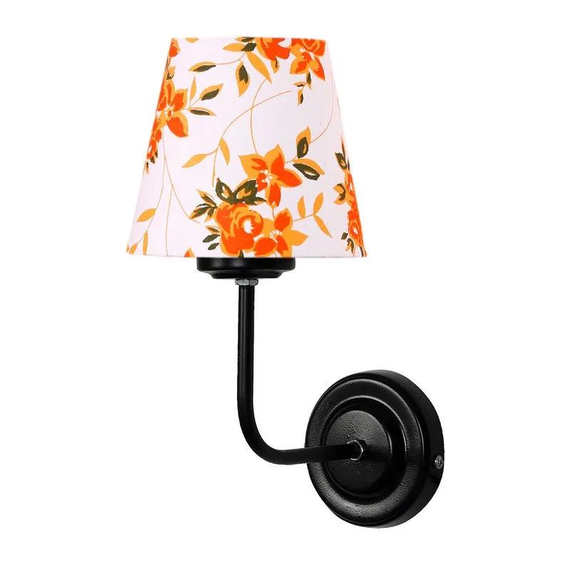 Angled view of black wall lamp with white and orange floral shade