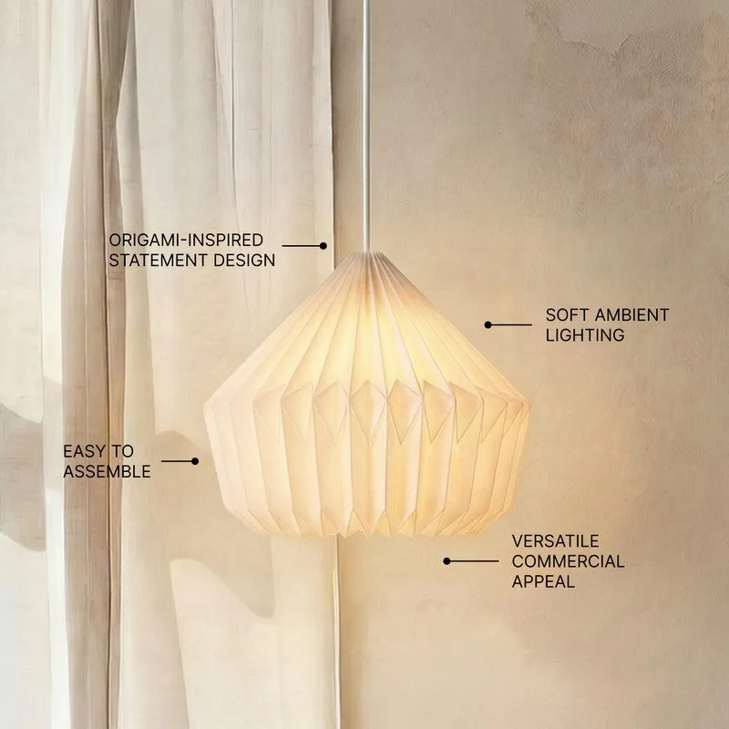 Glowing origami-style pendant lamp shown against soft draped fabric