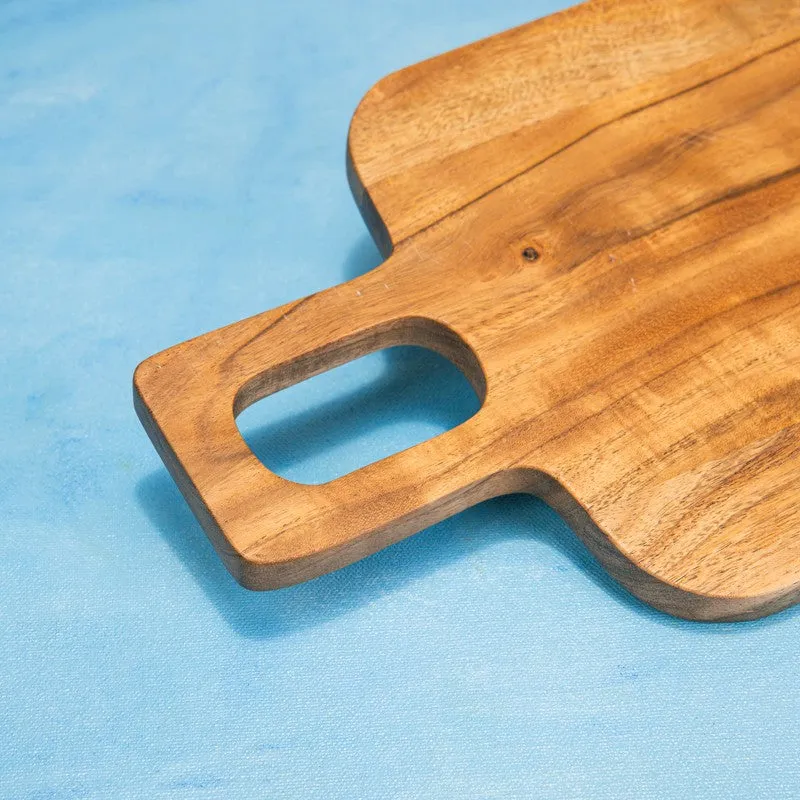 Close-up of a rounded handle opening on a brown wooden board