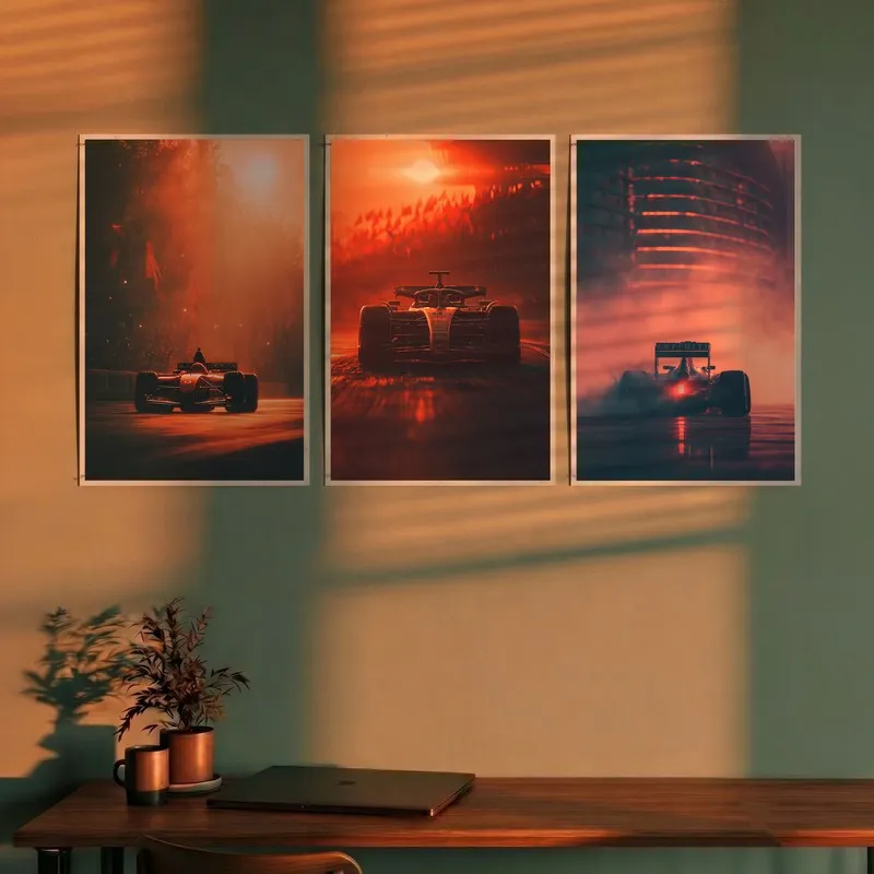 Three race car posters in warm orange tones displayed above a desk