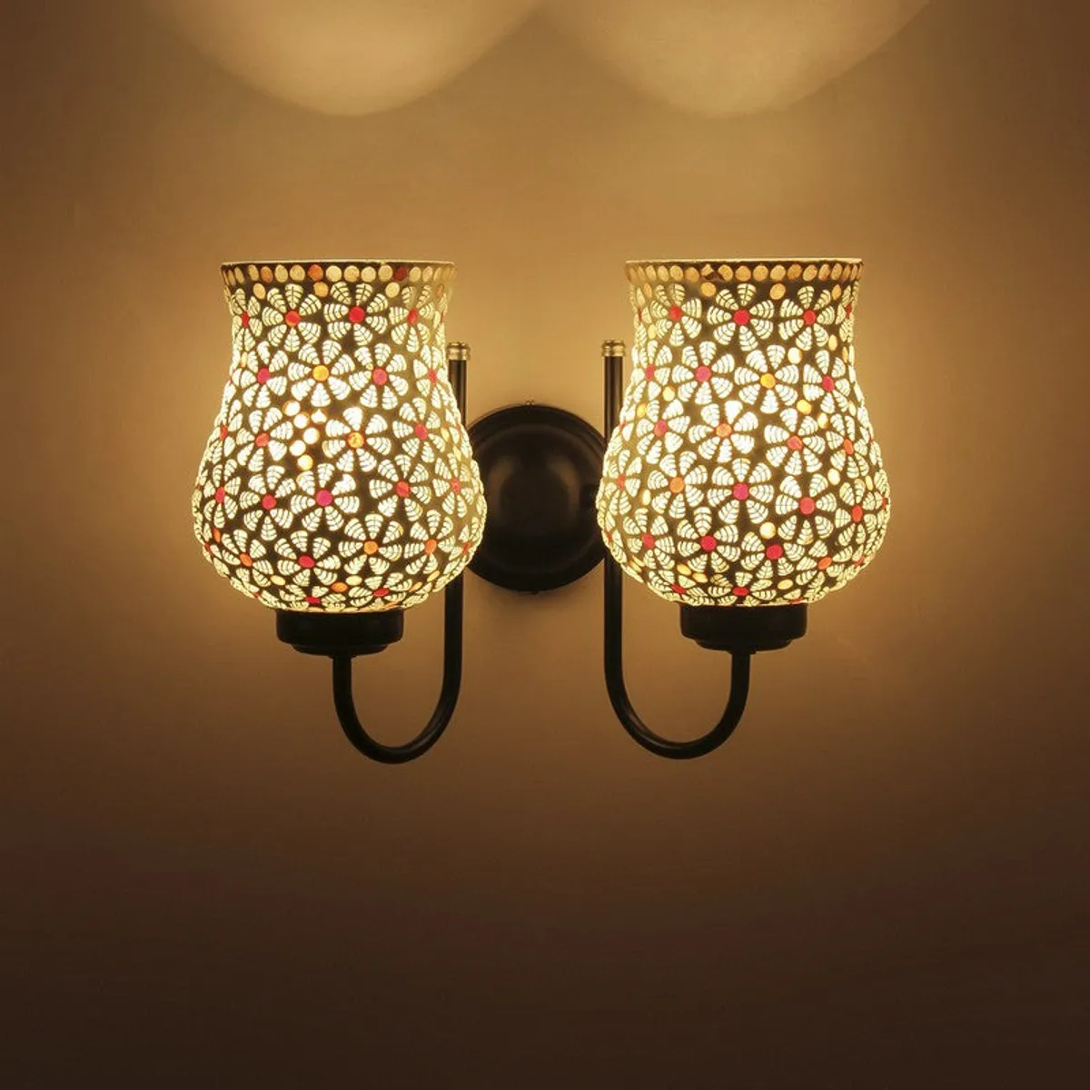 Lit dual wall lamp with warm glow and white bell-shaped glass shades