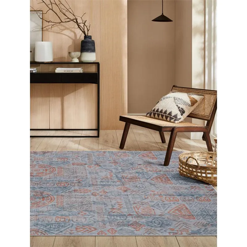 Blue and red patterned rectangular carpet styled in a living room