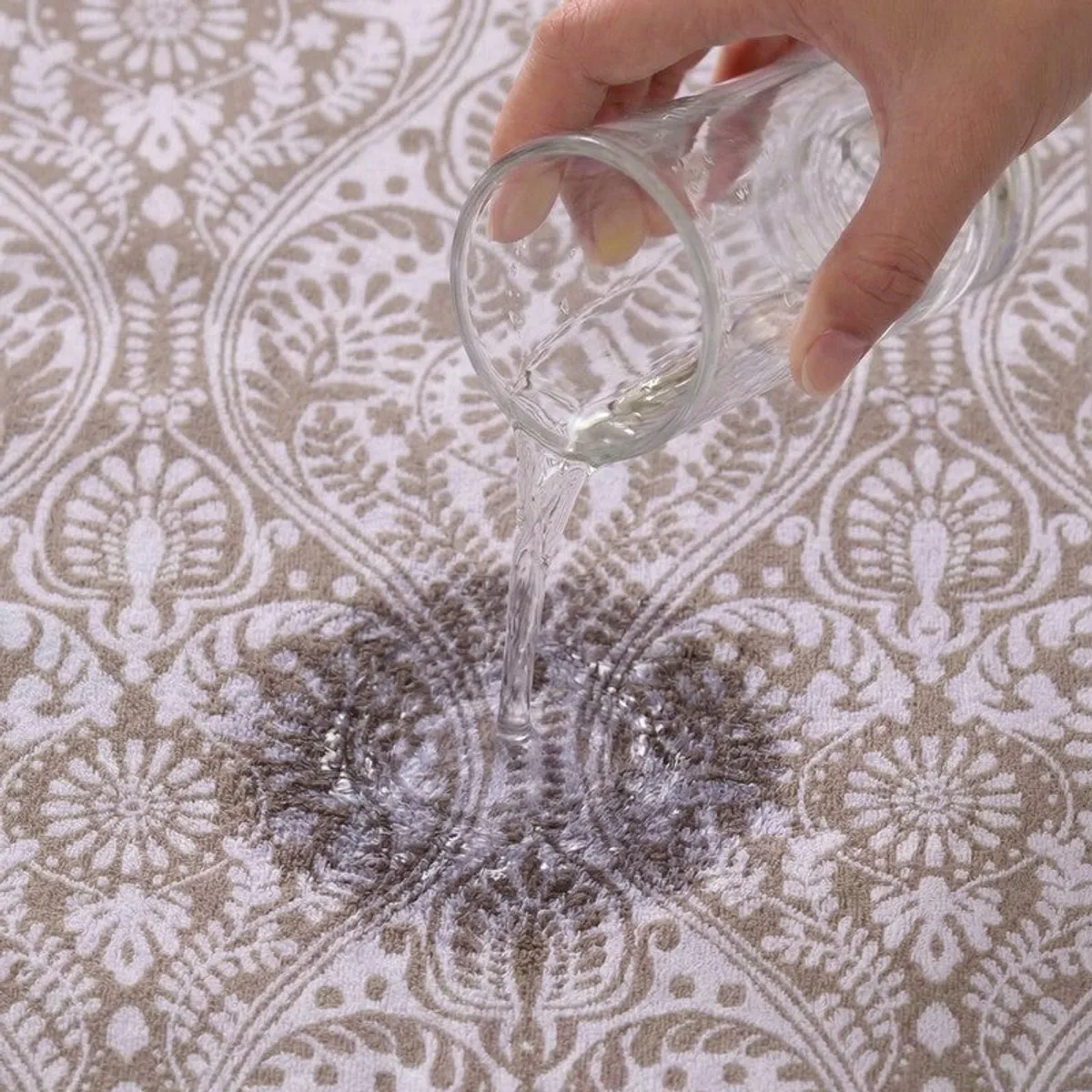 Water being poured onto the beige floral bath towel