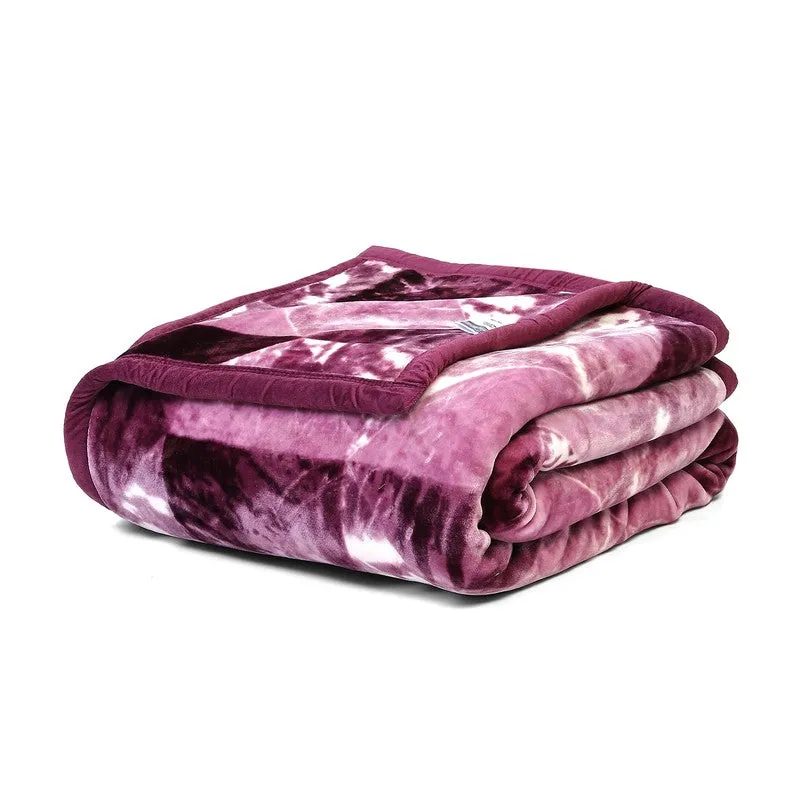 Folded violet blanket showing its plush surface and geometric pattern