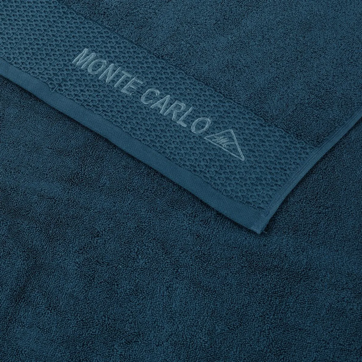 Close-up of blue towel texture and branded decorative border