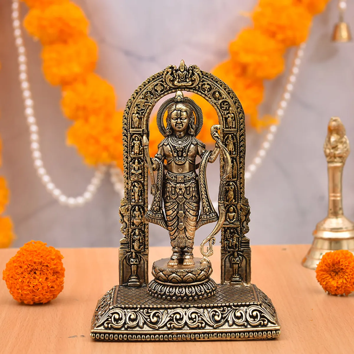 Sriramachandra brass idol displayed on a table with marigold decorations