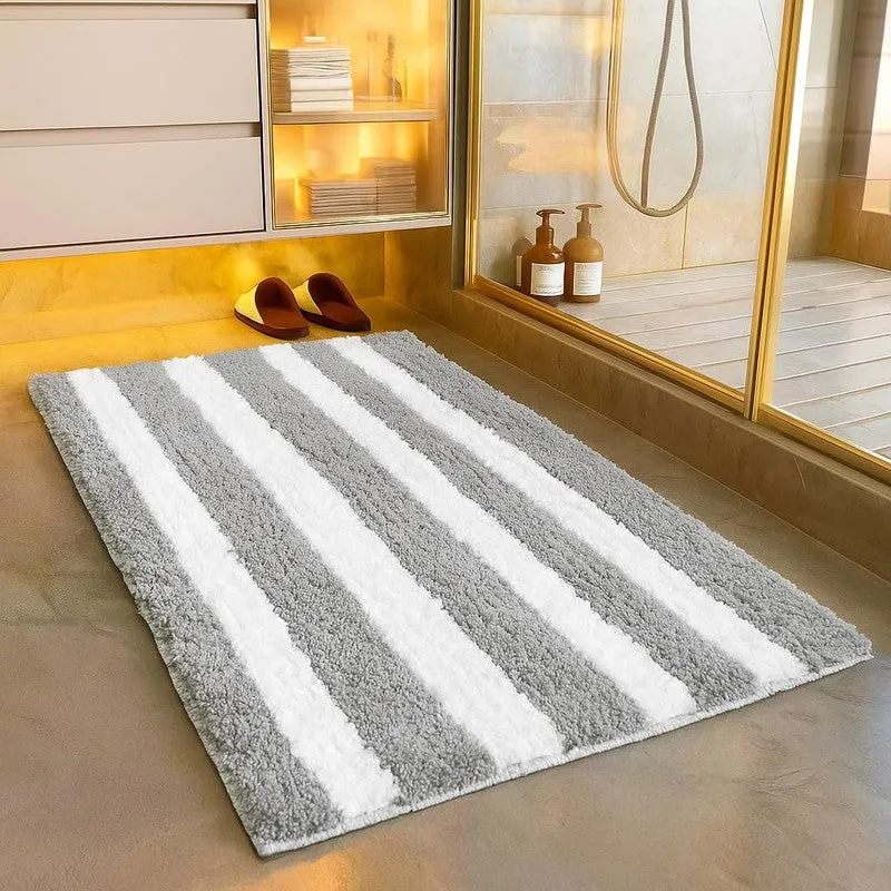Rectangular grey and white striped bath mat beside a shower area