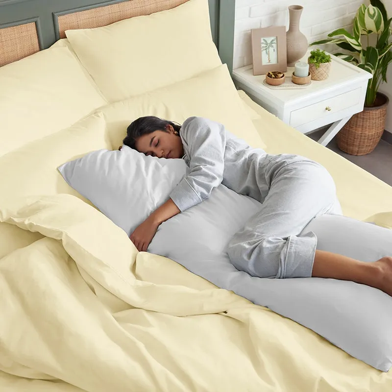 Ivory bedding set styled on a bed in a softly lit bedroom