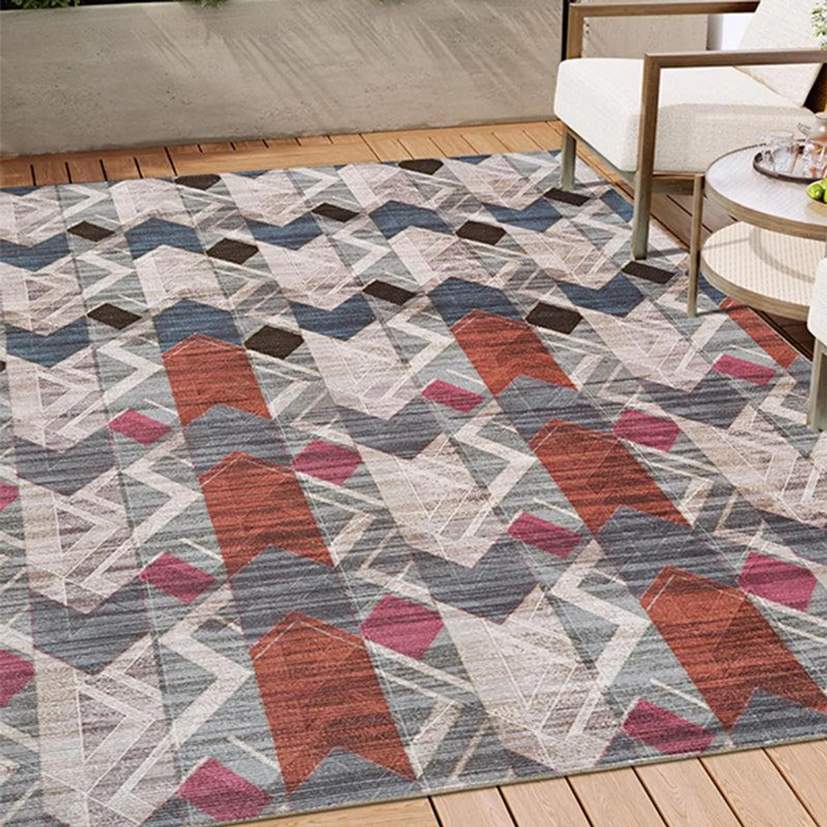 Geometric grey and red rectangular carpet placed in a living room setting