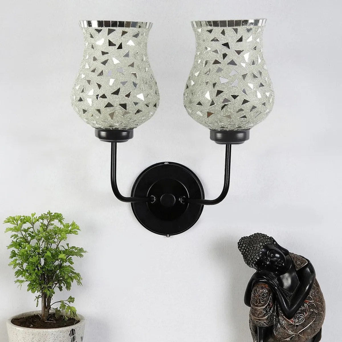 Silver mosaic twin wall lamp with black iron mount shown unlit against a white wall