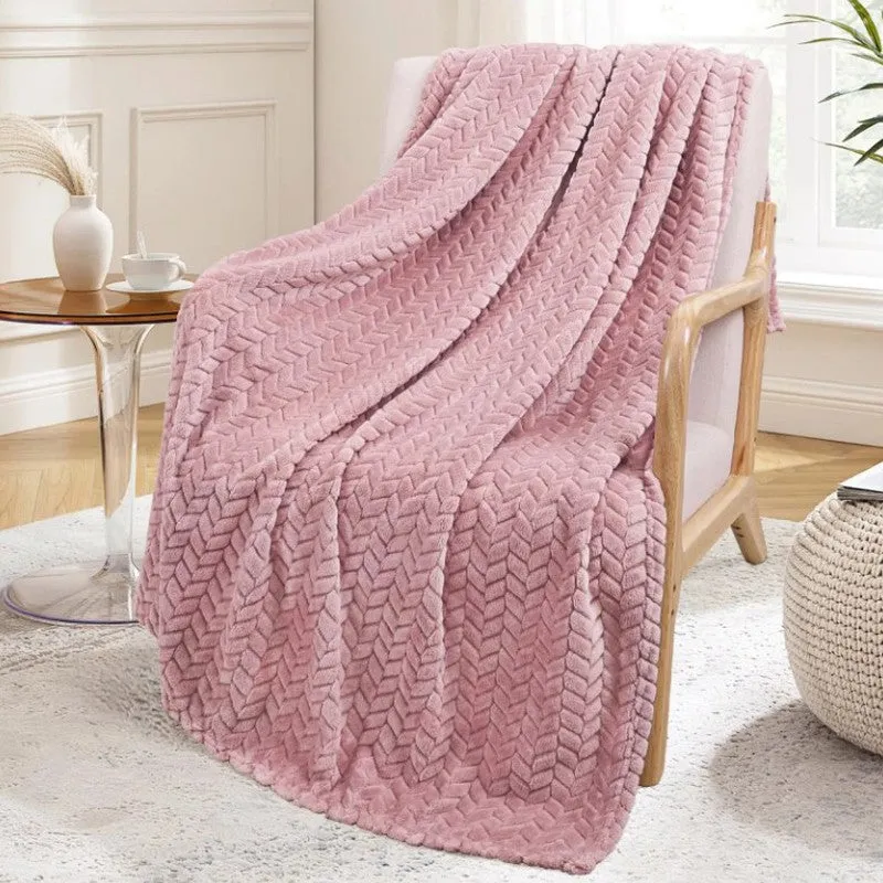 Peach chevron-textured blanket draped over a wooden armchair