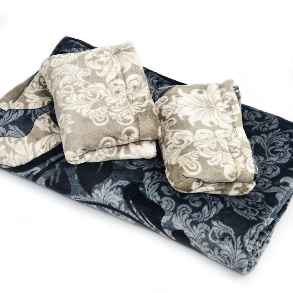 Folded black and beige patterned woolen bedsheet with pillow covers