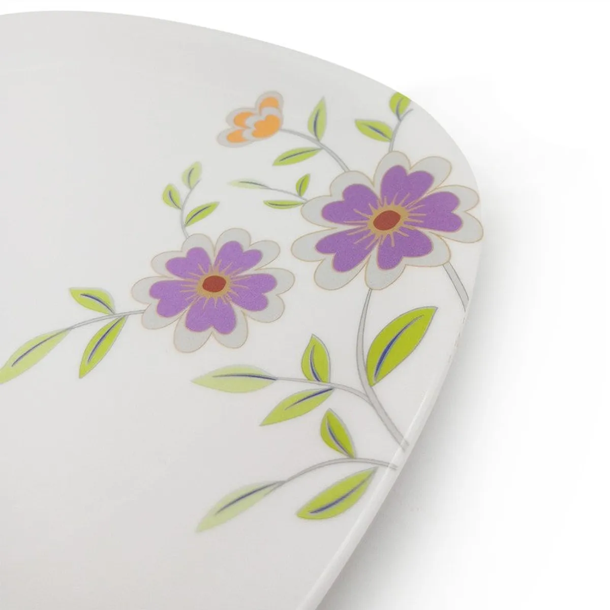 Close-up of purple flowers and green leaves on a white plate
