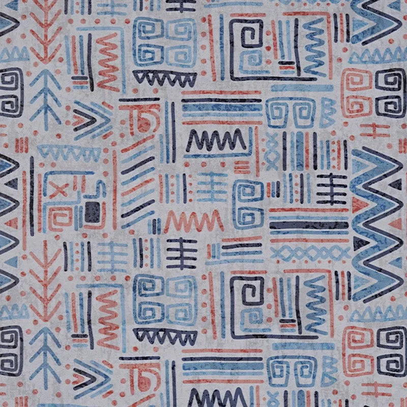 Detailed view of the carpet's abstract blue, orange and dark geometric pattern