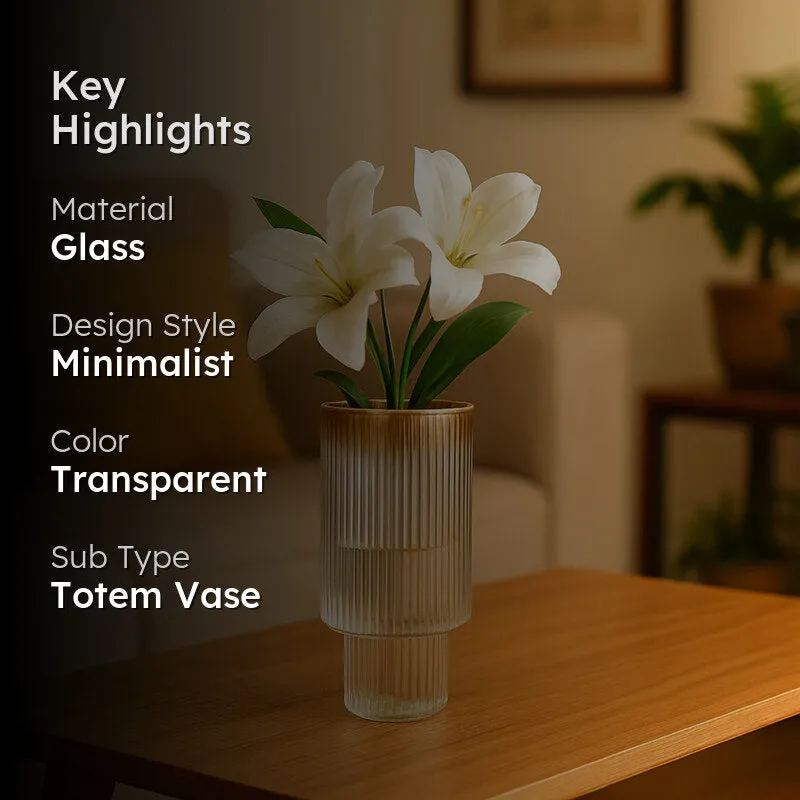 Ribbed glass vase with white flowers in a softly lit living room setting