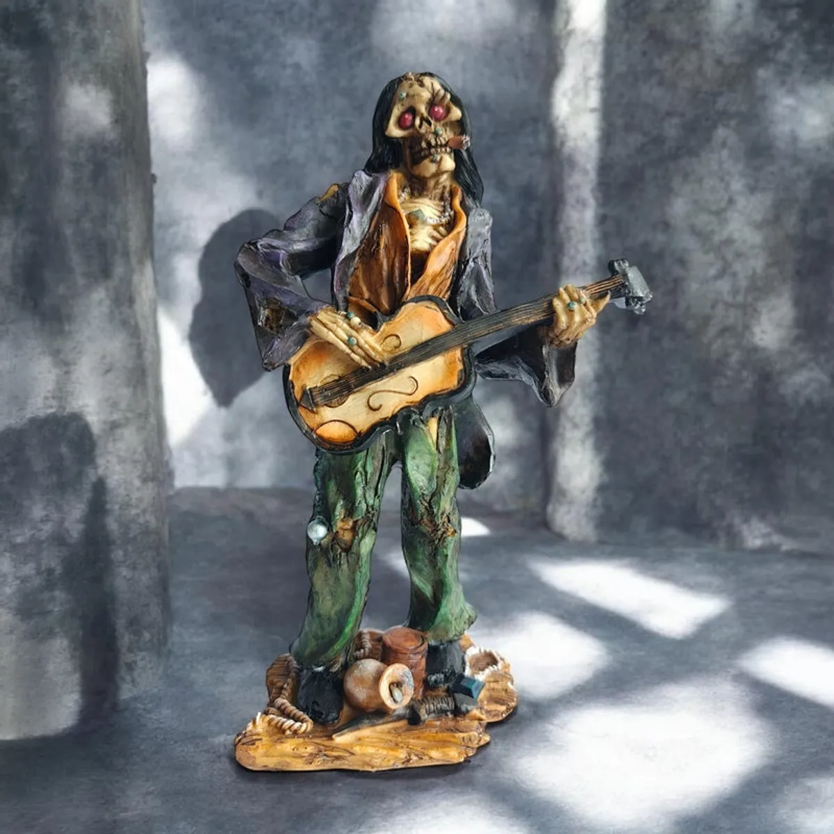 Front view of zombie guitarist figurine on a textured grey backdrop