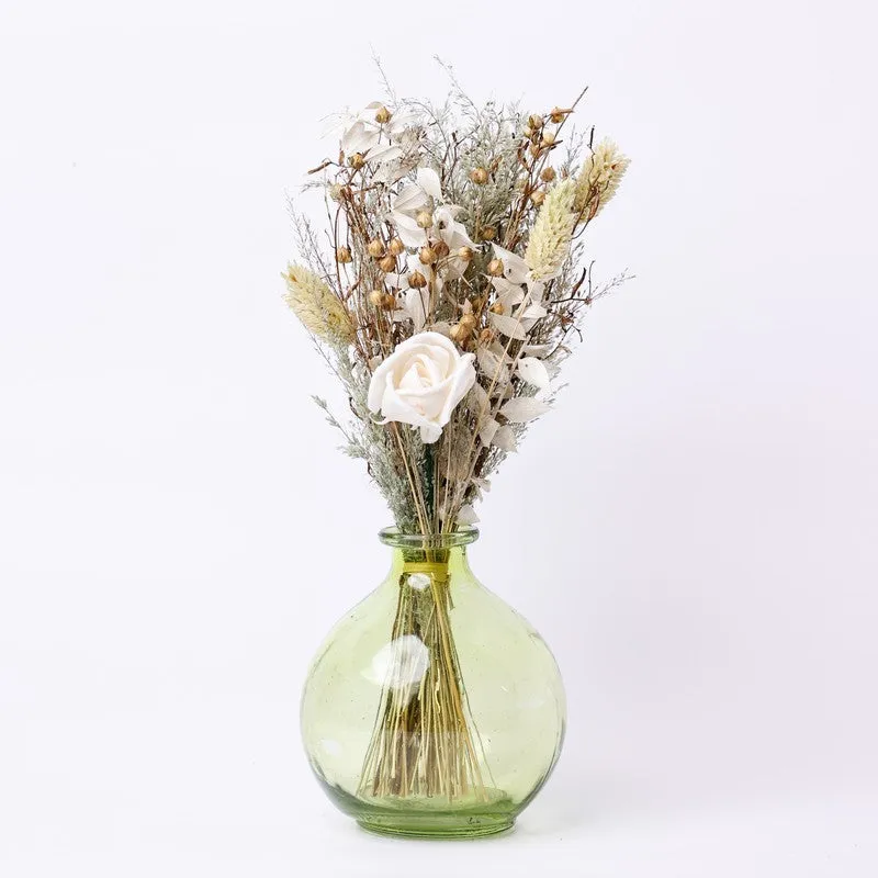 Jade dried flower arrangement with a pale green round vase on a white background