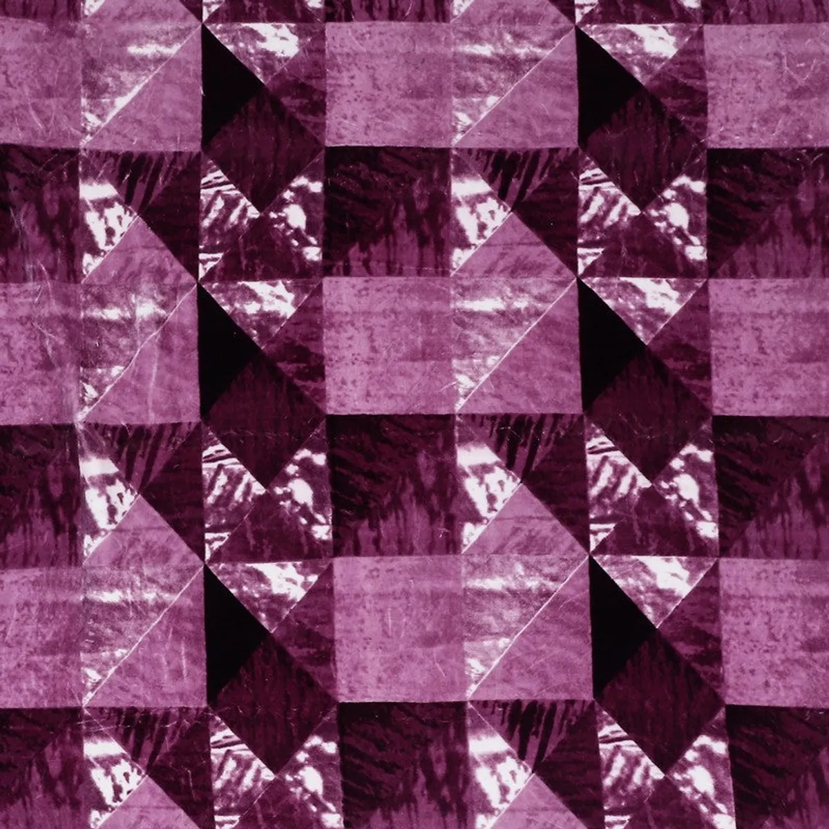 Close-up view of the blanket's purple and pink geometric pattern