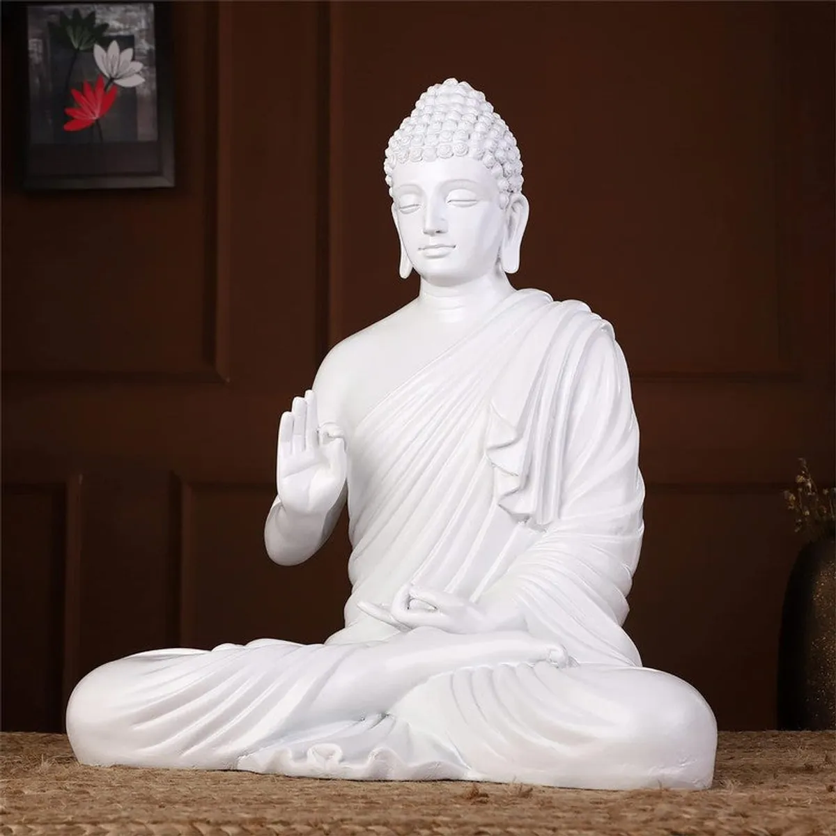 Angled view of a white Buddha idol seated in a meditative pose