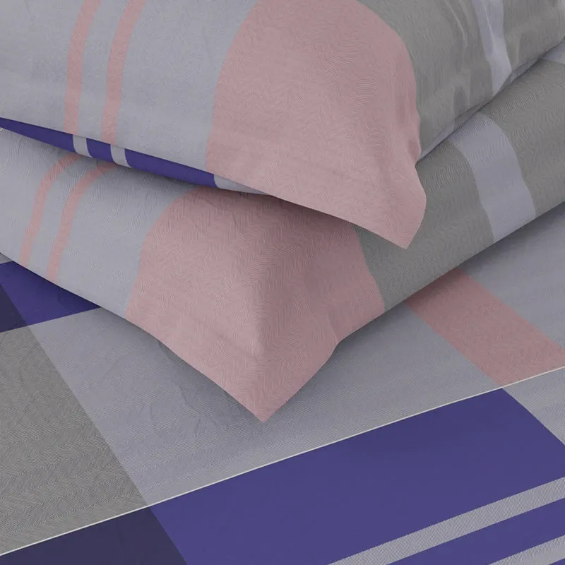 Close-up of soft purple, peach and grey geometric bedding fabric