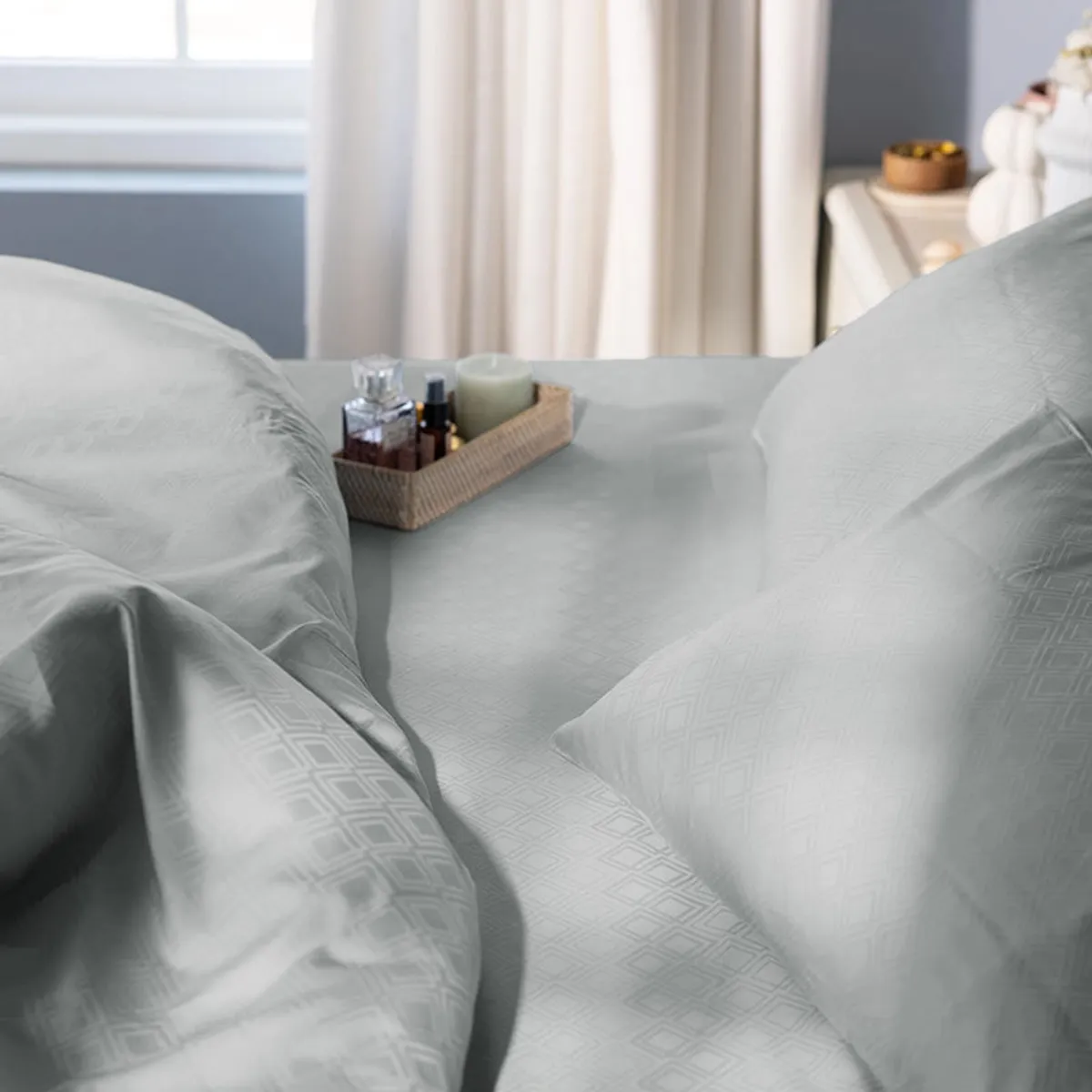 Close-up of the light grey geometric pattern on the duvet cover and pillows