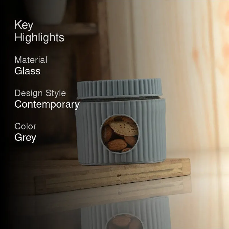 Grey ribbed jar displayed on a wooden board in a contemporary kitchen setting