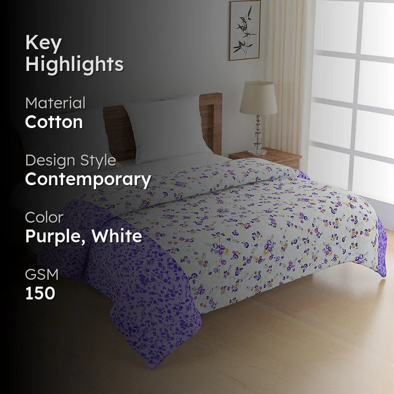 Purple and white floral comforter displayed on a bedroom bed