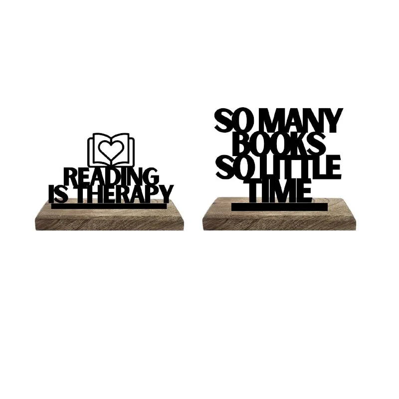 Two black typography showpieces on separate wooden bases against a white background