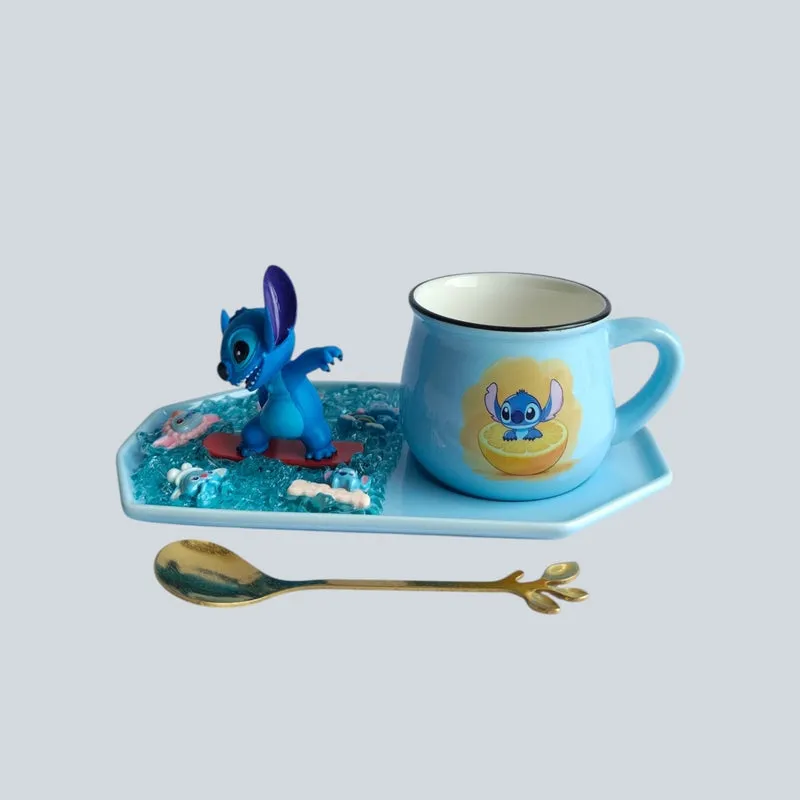 Blue ceramic character mug and figurine on a tray with a decorative spoon placed in front