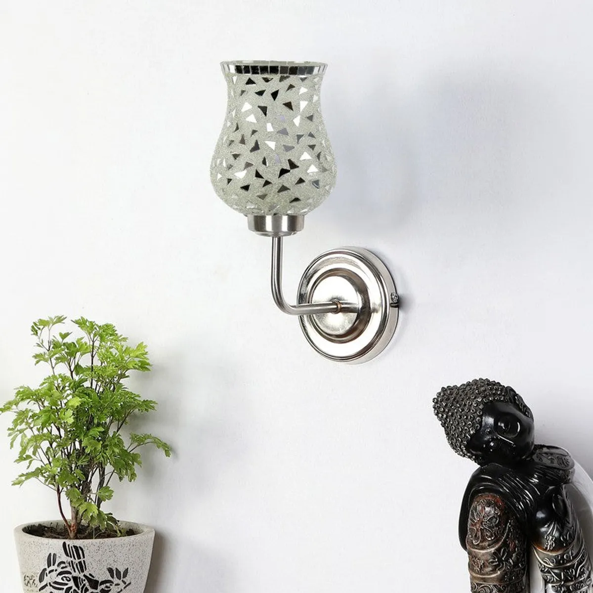 Silver mosaic glass wall lamp mounted on a white wall
