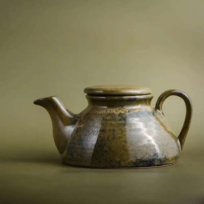 Green ceramic teapot with lid and curved handle