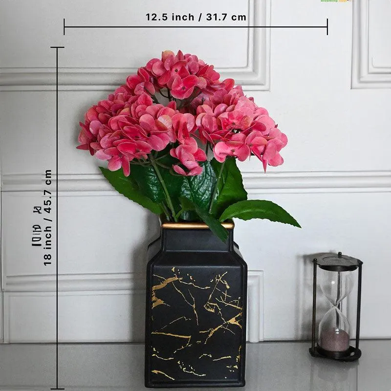 Pink artificial flower arrangement shown with dimensions beside a black vase.