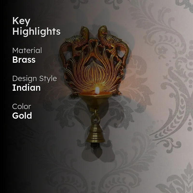 Gold brass peacock wall hanging diya shown lit with key highlights