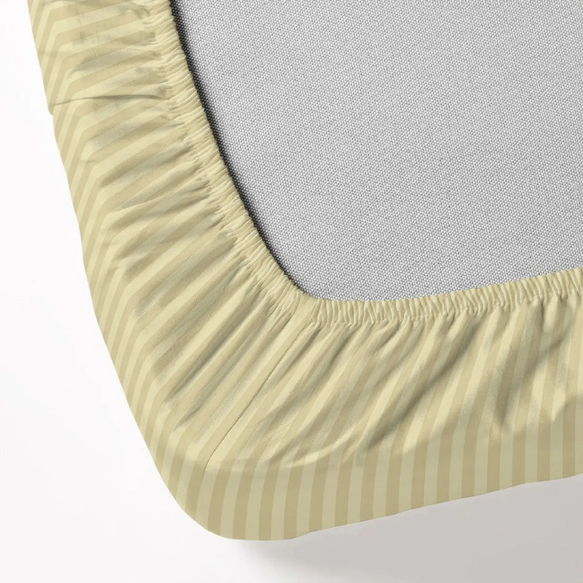 Close-up of the fitted bedsheet elasticised corner in beige striped fabric.