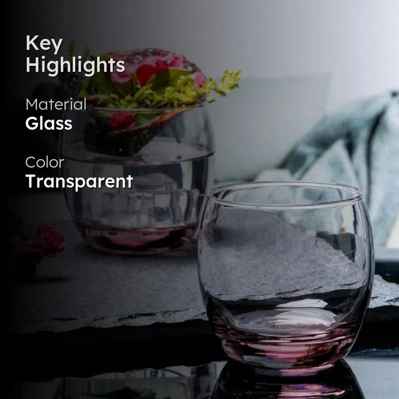 Lifestyle image of clear tumblers with pink bases on a table with flowers