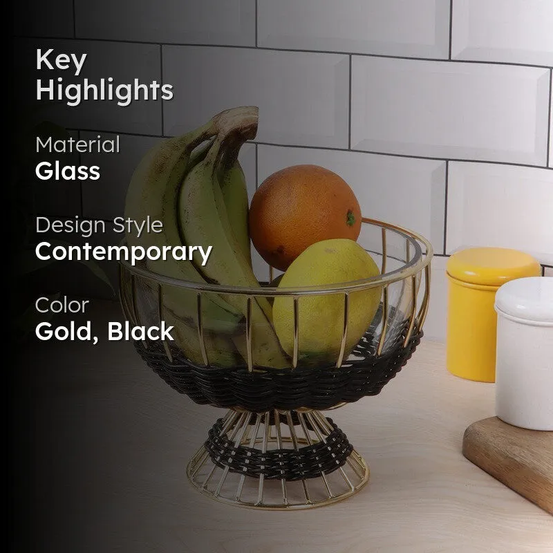 Lifestyle view of the black and gold bowl with fruit against a tiled kitchen wall.