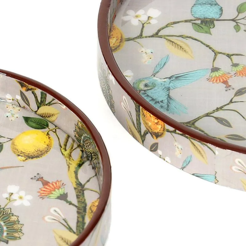Close-up of round tray edges and detailed bird, lemon, flower and leaf artwork.