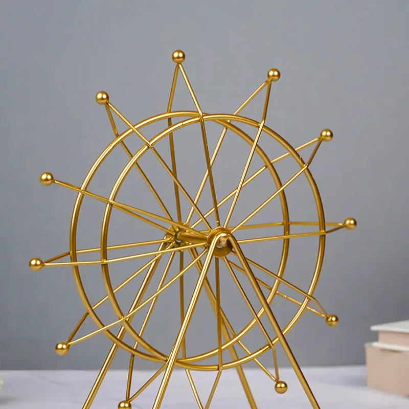 Angled view of a gold Ferris wheel showpiece with open metal frame