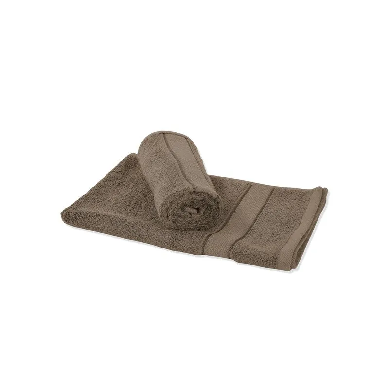 Rolled and folded grey towel on a white background