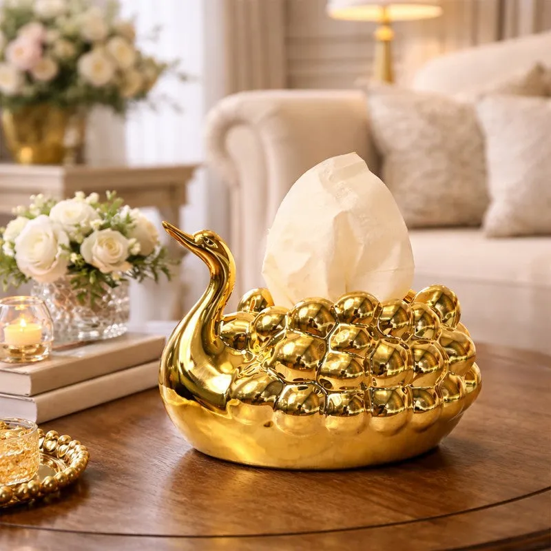 Gold swan tissue holder styled on a wooden living room table