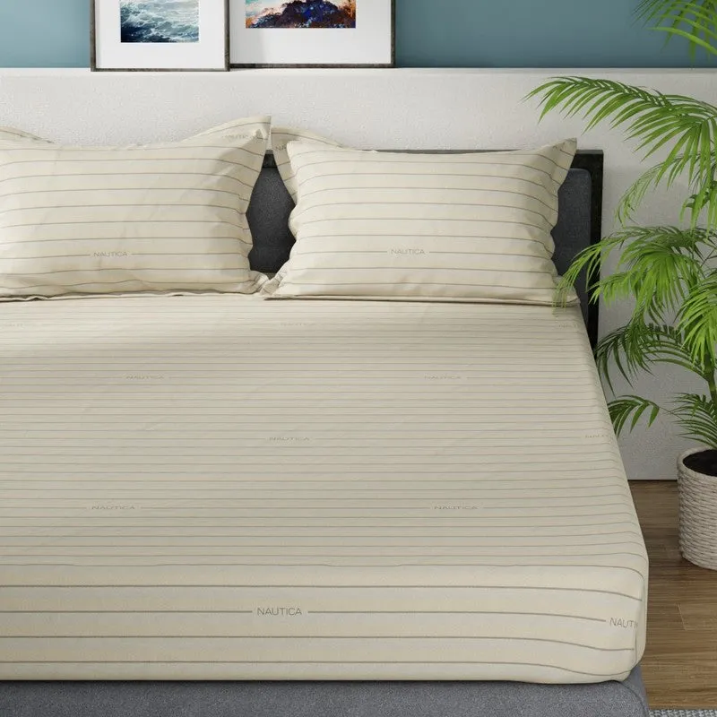Close view of brown striped bedsheet and matching striped pillow covers