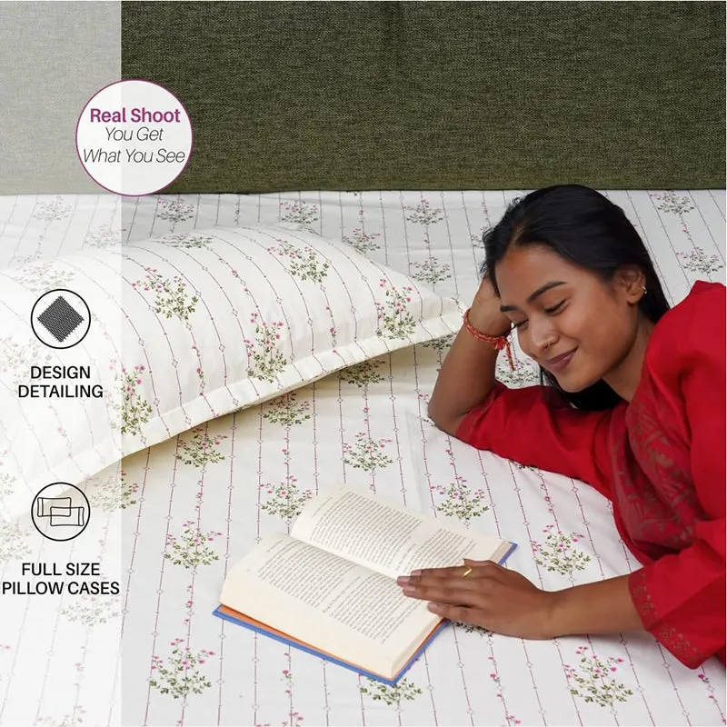 Woman resting on floral striped bedsheet beside a matching pillow cover